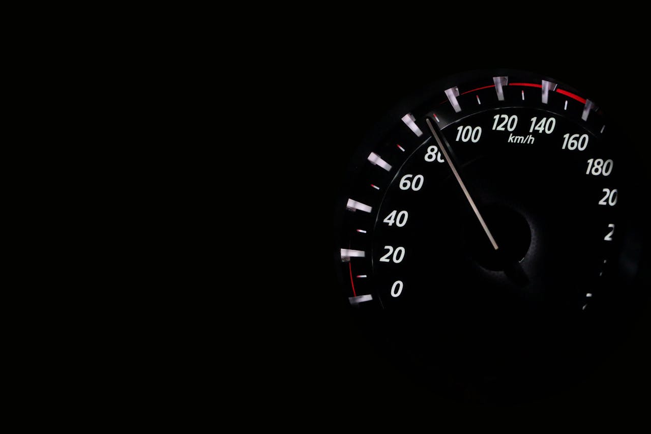 why-choose-us Speedometer reading showing speed in km/h on a dark background.